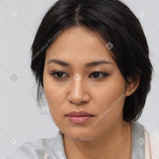 Joyful asian young-adult female with medium  black hair and brown eyes