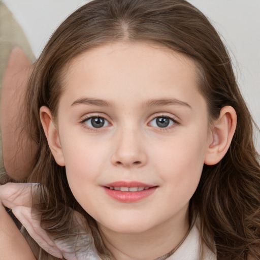 Joyful white child female with long  brown hair and brown eyes