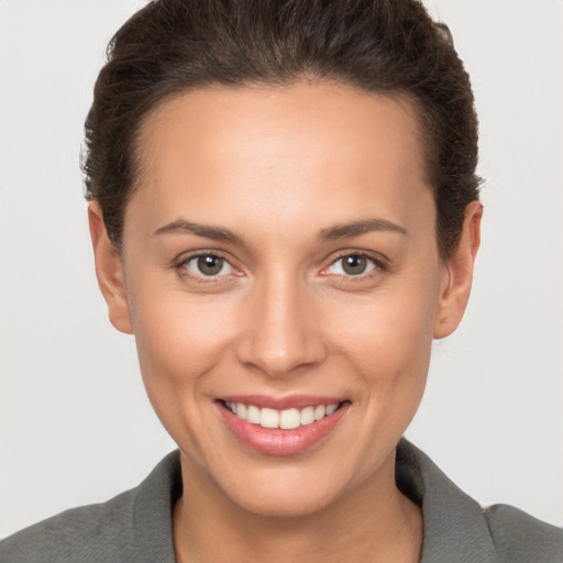 Joyful white young-adult female with short  brown hair and brown eyes