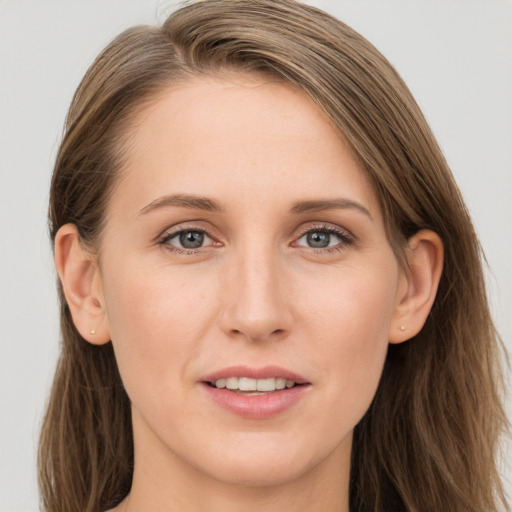 Joyful white young-adult female with long  brown hair and grey eyes