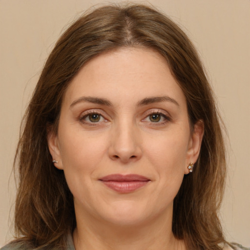 Joyful white young-adult female with long  brown hair and green eyes