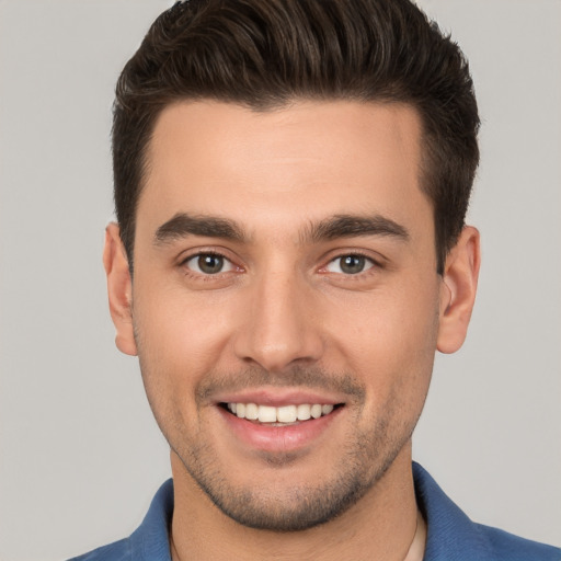 Joyful white young-adult male with short  brown hair and brown eyes