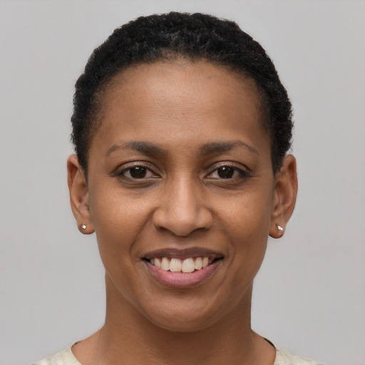 Joyful black young-adult female with short  brown hair and brown eyes