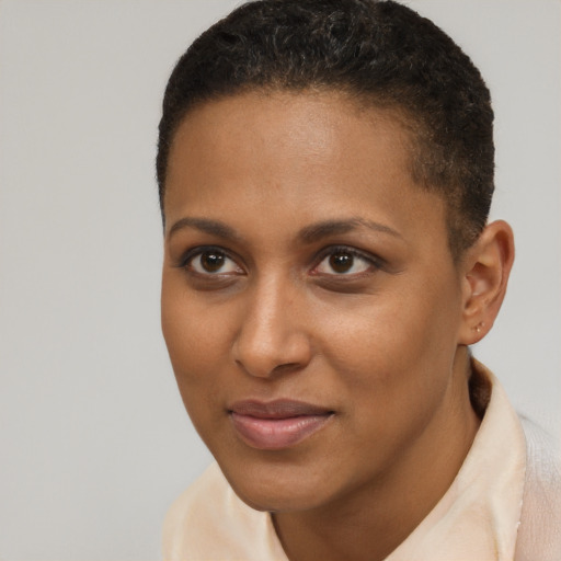 Joyful black young-adult female with short  brown hair and brown eyes