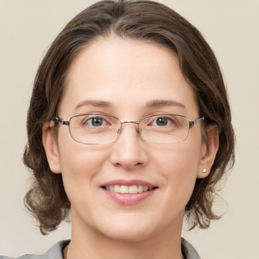 Joyful white adult female with medium  brown hair and grey eyes