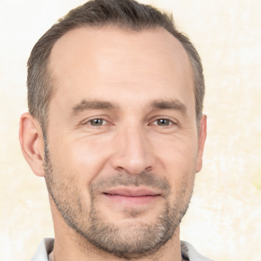 Joyful white adult male with short  brown hair and brown eyes