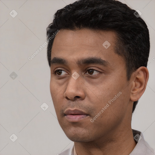 Neutral latino young-adult male with short  black hair and brown eyes