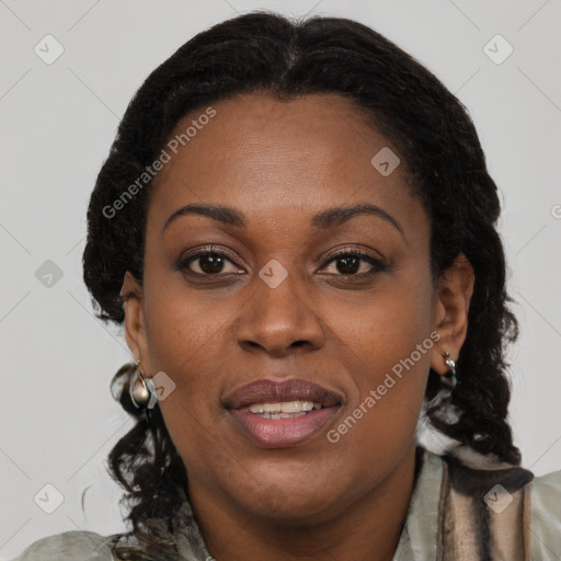 Joyful black adult female with long  brown hair and brown eyes