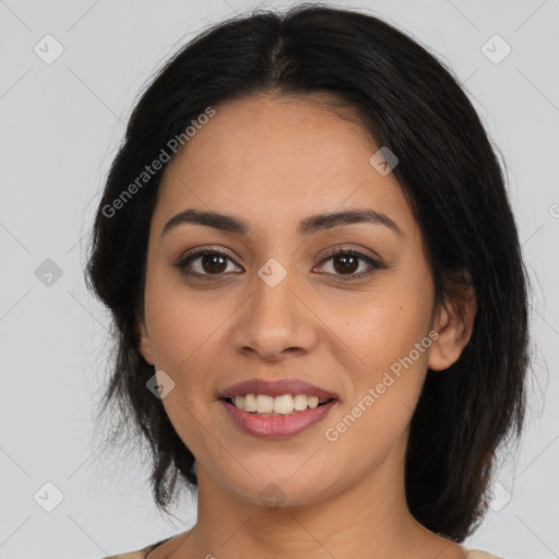 Joyful latino young-adult female with medium  brown hair and brown eyes