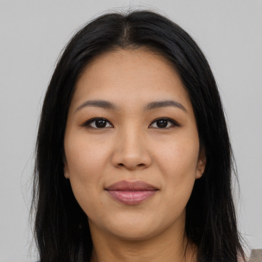 Joyful asian young-adult female with long  brown hair and brown eyes