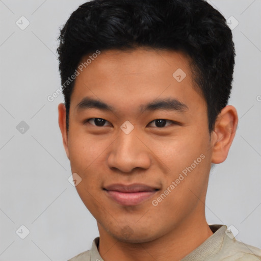 Joyful asian young-adult male with short  black hair and brown eyes