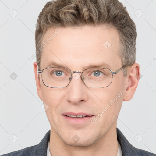 Joyful white adult male with short  brown hair and grey eyes