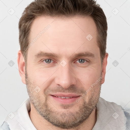 Joyful white adult male with short  brown hair and grey eyes