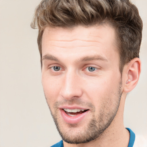 Joyful white young-adult male with short  brown hair and grey eyes