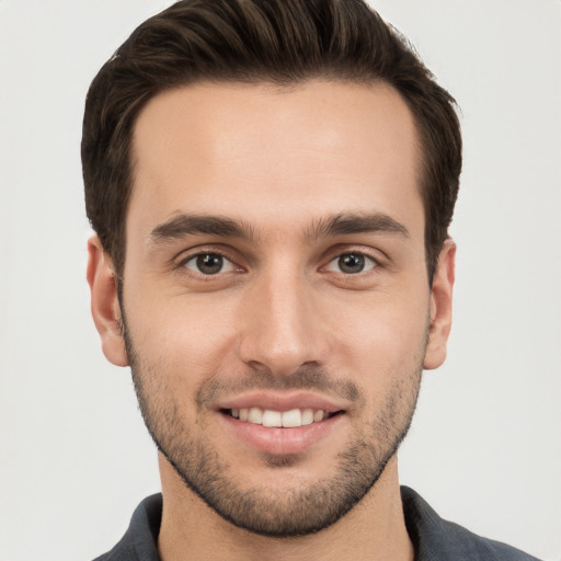 Joyful white young-adult male with short  brown hair and brown eyes