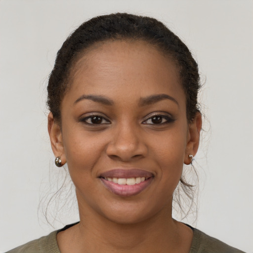 Joyful black young-adult female with short  brown hair and brown eyes