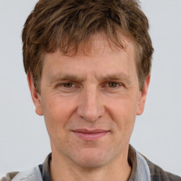 Joyful white adult male with short  brown hair and grey eyes