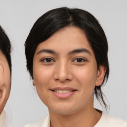 Joyful asian young-adult female with medium  black hair and brown eyes