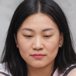 Joyful asian young-adult female with long  brown hair and brown eyes