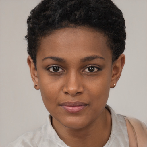 Joyful black young-adult female with short  black hair and brown eyes