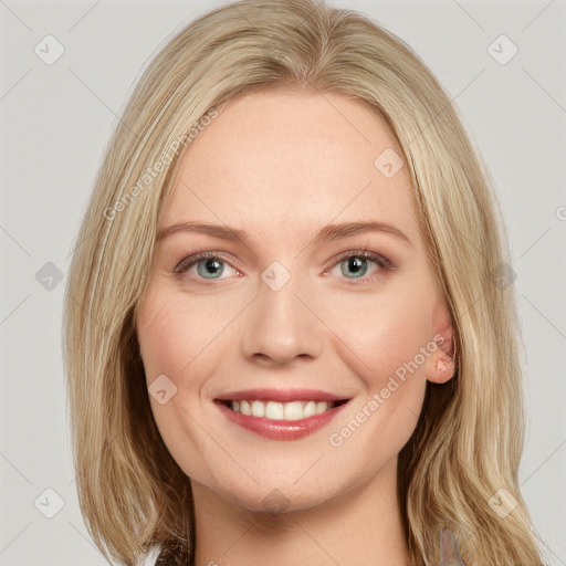 Joyful white young-adult female with long  brown hair and blue eyes