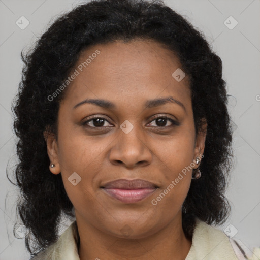 Joyful black adult female with long  brown hair and brown eyes