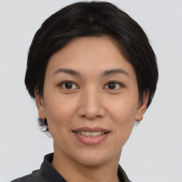 Joyful asian young-adult female with short  black hair and brown eyes