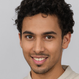 Joyful latino young-adult male with short  brown hair and brown eyes