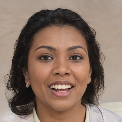Joyful latino young-adult female with medium  brown hair and brown eyes