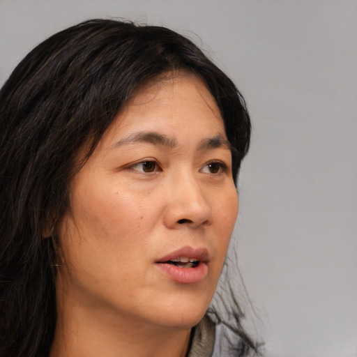 Neutral asian adult female with long  brown hair and brown eyes