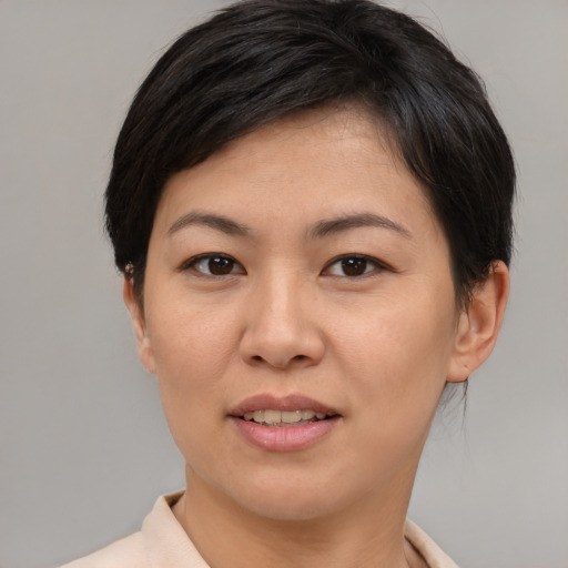 Joyful asian young-adult female with short  brown hair and brown eyes