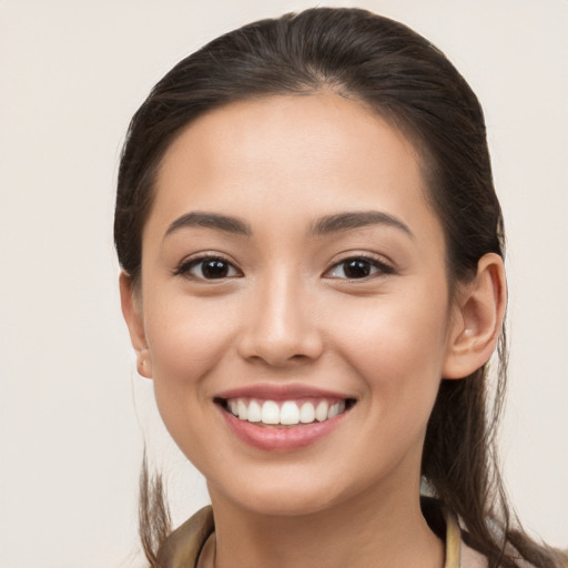 Joyful white young-adult female with long  brown hair and brown eyes