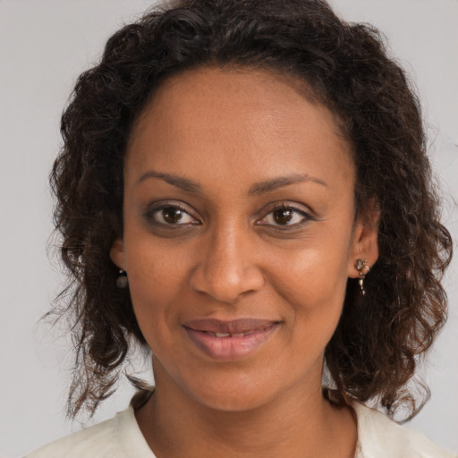 Joyful black young-adult female with medium  brown hair and brown eyes