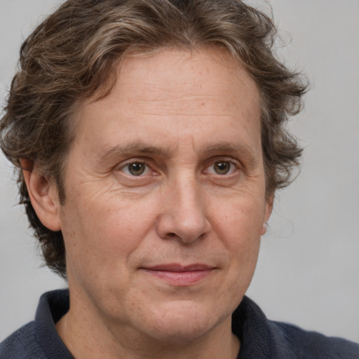 Joyful white middle-aged male with medium  brown hair and brown eyes