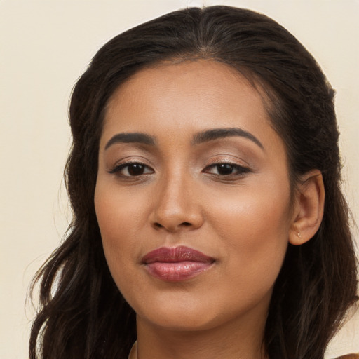 Joyful white young-adult female with long  brown hair and brown eyes