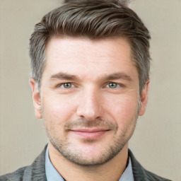 Joyful white adult male with short  brown hair and grey eyes