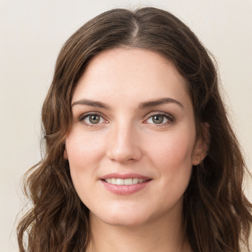 Joyful white young-adult female with long  brown hair and green eyes