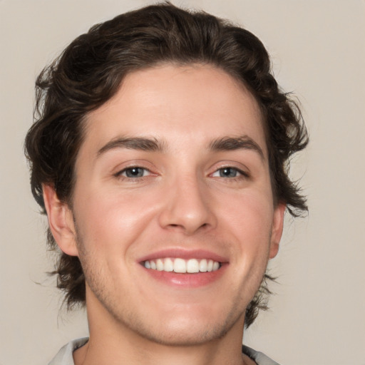 Joyful white young-adult male with medium  brown hair and brown eyes