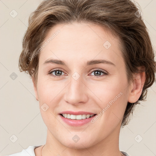 Joyful white young-adult female with short  brown hair and brown eyes