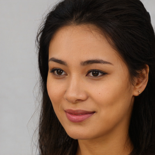 Joyful asian young-adult female with long  brown hair and brown eyes