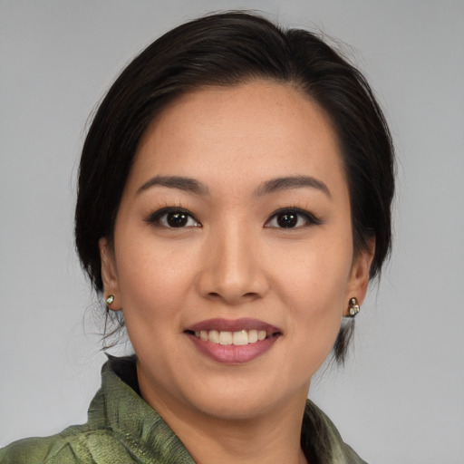 Joyful asian young-adult female with medium  black hair and brown eyes