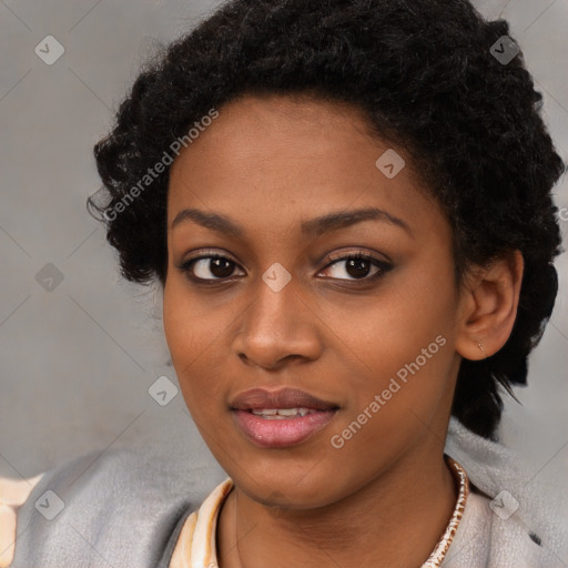 Joyful black young-adult female with long  black hair and brown eyes