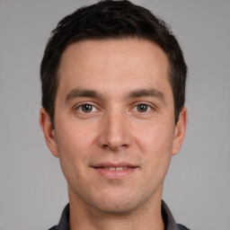 Joyful white young-adult male with short  brown hair and brown eyes