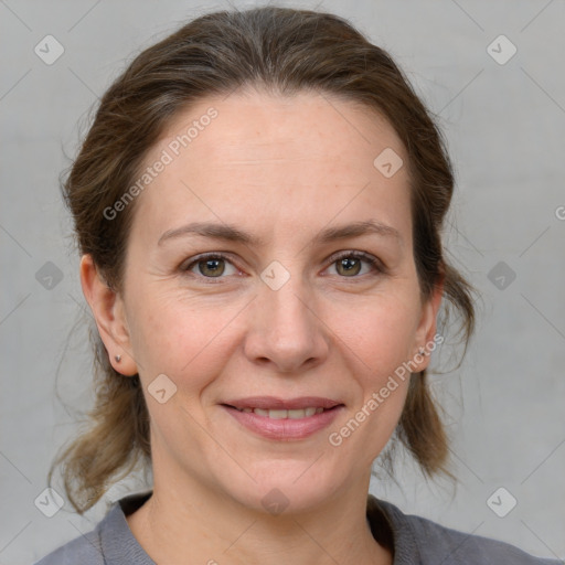 Joyful white adult female with medium  brown hair and grey eyes