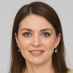 Joyful white young-adult female with long  brown hair and green eyes