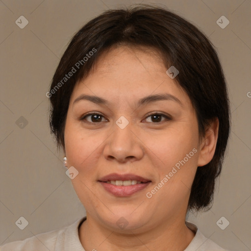 Joyful latino adult female with medium  brown hair and brown eyes