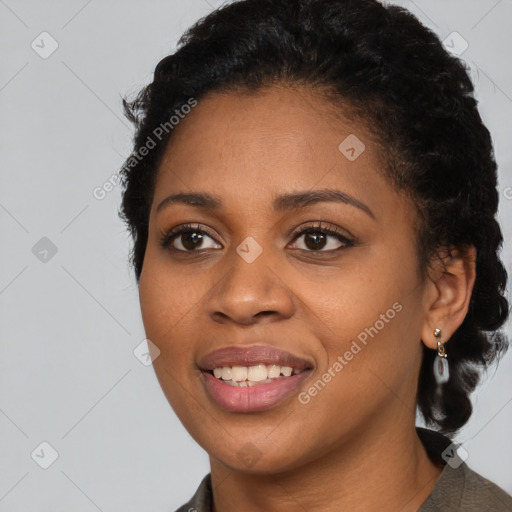 Joyful black young-adult female with short  black hair and brown eyes