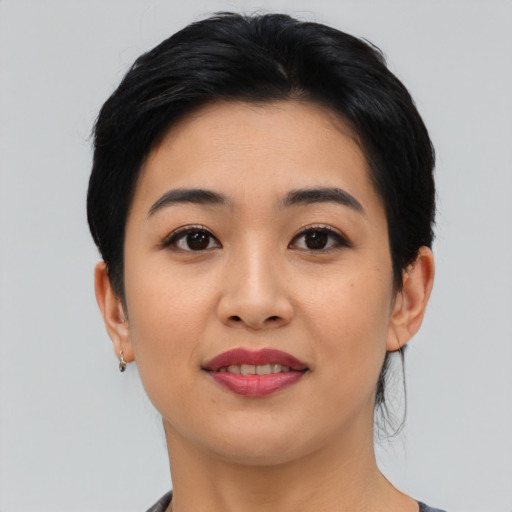 Joyful asian young-adult female with medium  black hair and brown eyes