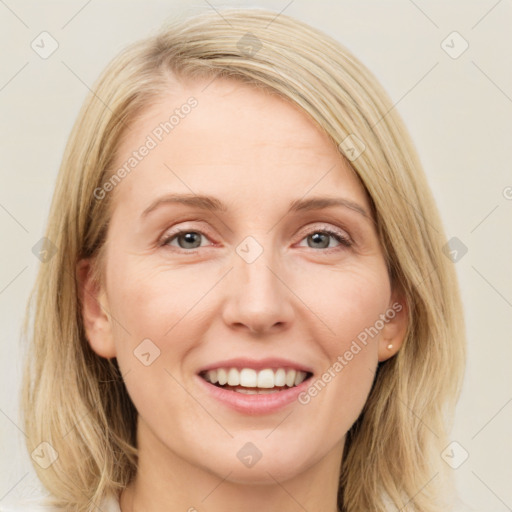 Joyful white young-adult female with medium  brown hair and blue eyes