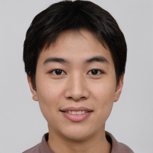 Joyful asian young-adult male with short  brown hair and brown eyes